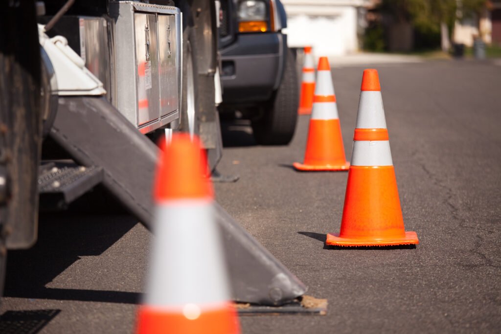 several-orange-hazard-cones-and-utility-truck